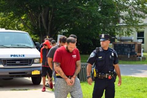 Gilberto Quintana-Crespo, in front, was among the many defendants led into East Hampton Town Justice Court last Thursday to be arraigned on charges related to the takedown of what investigators said was the “largest narcotics distribution ring in and around Montauk.”