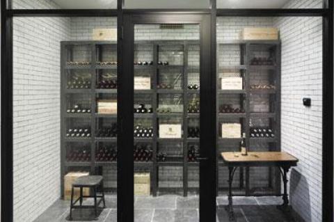 In a house he designed and built on Further Lane in East Hampton Village, Dan Scotti created a wine cellar in the basement with a glass storefront, all the better to admire the wine collection.