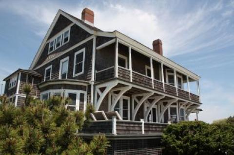 Perched above the beach at Georgica, Kilkare boasts chevron-ribbed ceilings, wide-plank pumpkin pine floors, and the grand staircase with the widened treads to accommodate women wearing Victorian gowns.