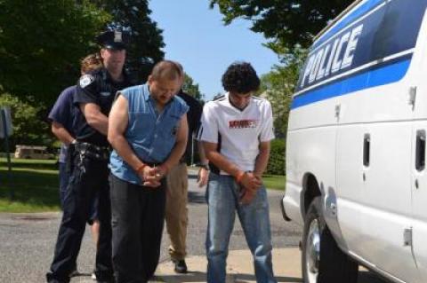 Juan P. Porras and Jose Jaime Restrepo-Perez of Springs were led to their arraignments in East Hampton Town Justice Court Thursday morning.