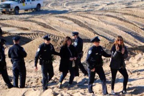 Lisa Spellman, who flashed a peace sign, and Bess Rattray, were arrested on disorderly conduct charges Monday morning.