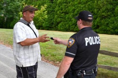 An East Hampton Village police officer handed Matt Agudo his lens cap after an alleged scuffle with Alec Baldwin.