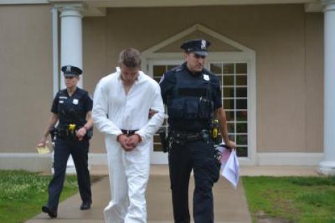 Matthew Patrick McGee, a petty officer third class with the Coast Guard, was led out of East Hampton Town Justice Court on Monday, accused of beating up a woman in Montauk.