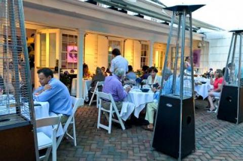 The brick patio of Maison Vivienne, which overlooks Southampton’s Main Street but is hidden behind hedges, was lively on a pleasant Tuesday evening.