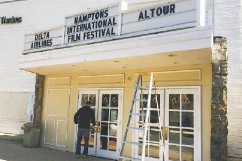 Employees at the East Hampton Cinema prepared for the Hamptons International Film Festival yesterday, changing the marquee for the coming event.