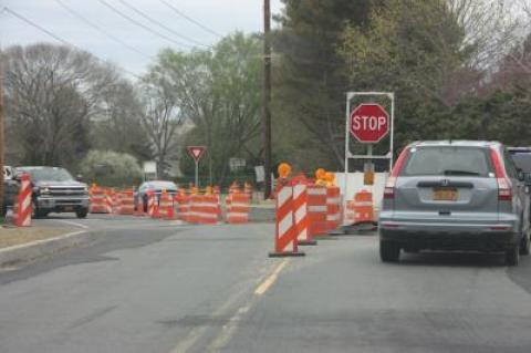 Although the roundabout won't be finished by Memorial Day weekend, installation of splitter islands and a curb around the center circle will reduce the number of safety barrels there.