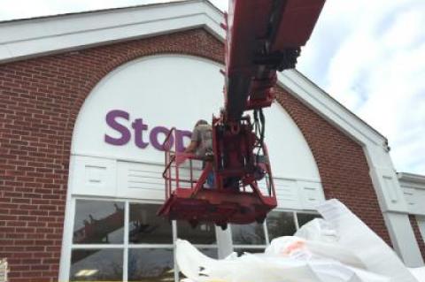 In with the new: A worker hung the new Stop and Shop sign on the former Waldbaum's store on Oct. 9.