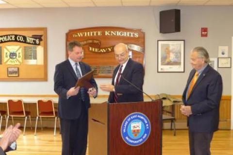 As he stepped down as East Hampton Village police chief, Jerry Larsen was praised at a village board meeting in January 2017 by both Richard Lawler, center, and Mayor Paul F. Rickenbach Jr., right. Later that year, he sued both of them, and the village.