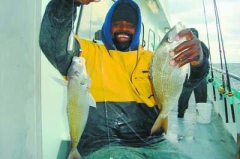 Gil Parker hefted two fat porgies