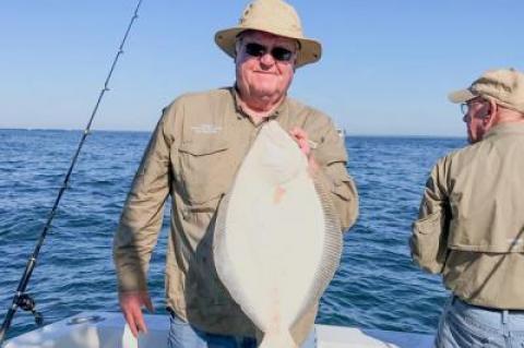 John Brosnan held a fluke caught in more pleasant weather aboard Breakaway, a charter boat out of Montauk. As of last month, all party and charter boats are now required to file electronic catch reports on certain fish, including fluke.