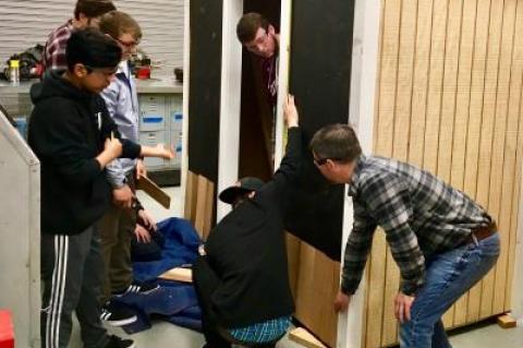 Andrew Rigby, right, the technology and manufacturing teacher at East Hampton High School, gave a lesson on shingling the exterior of a building, as part of a building trades class.