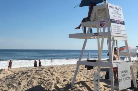 Lifeguards kept watch on the ocean at Main Beach in East Hampton on Wednesday afternoon, where they were flying a yellow flag, not because of the shark bites in the water off Fire Island, but because of rough conditions.