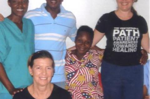 Mitten Wainwright, seated at left, and Liz Lattuga, standing at right, spent a recent week in Haiti showing hospital caregivers techniques for maintaining their own health.