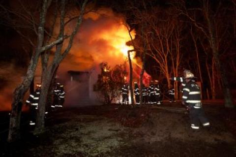 Sag Harbor firefighters battle a blaze on Robeson Boulevard in Sag Harbor Village late Wednesday evening.