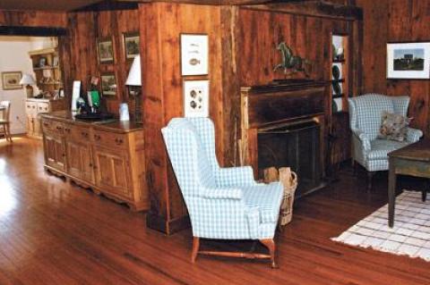 Wooden beams, along with wood walls and floors, speak of the house’s age, while most of the furnishings are vintage.