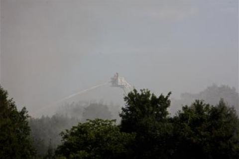 From a bucket on a ladder truck, firefighters doused the flames shooting from a house on Wyandanch Lane in Southampton.