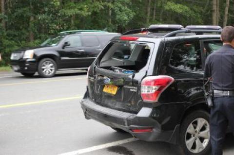 A utility truck rear-ended a Subaru Forester, which then hit the back of a school bus. No children were on board the bus.