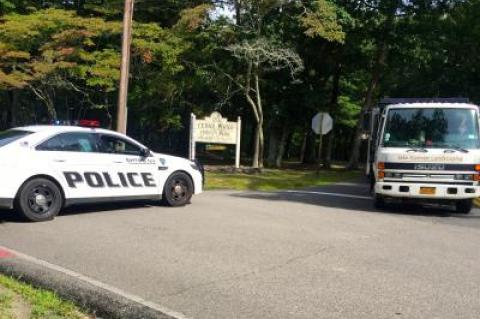 Police blocked Alewife Brook Road near the entrance to Cedar Point County Park while they investigate a death.