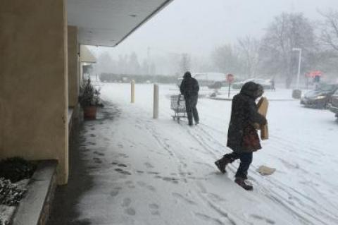 Last customers carefully traversed the snow outside the Amagansett I.G.A. before it closed at 9:45 a.m.