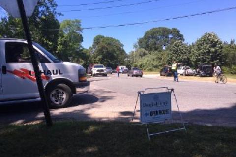 Traffic backed up at the circle as emergency workers closed down one lane of Route 114 as they dealt with the accident in the woods.