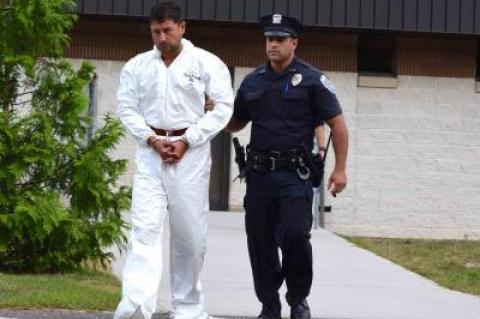 Sean P. Ludwick, a major real estate developer in Manhattan, was led out of the Southampton Town Police Department for his arraignment on Monday. He is accused of driving drunk in a crash that left his passenger, Paul Hansen, dead.