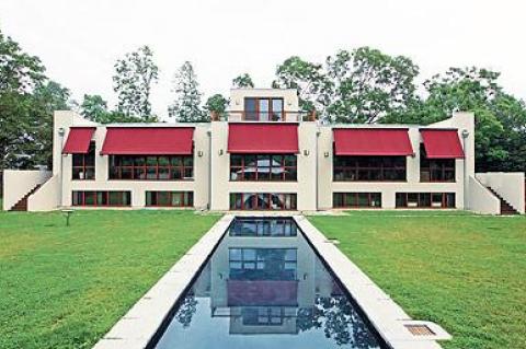 The south side of Don and Tori Matheson’s house in Springs is seen with awnings deployed for shade, above, and retracted for full sun, inset.