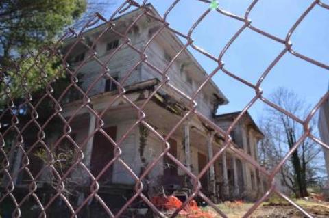 The mortgage holder agreed to put a fence around the two exposed sides of the former Morpurgo property, as village officials consider tearing the house down in the name of public safety.