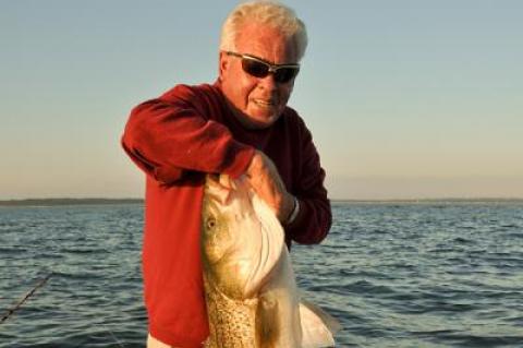 Capt. John Rade, seen here with a massive striped bass, will be honored as the Fishing Legend of the Year at the conclusion of the Montauk Mercury Grand Slam Fishing Tournament on Sunday.