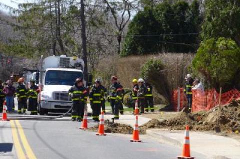 East Hampton firefighters stood by while National Grid remedied a gas leak, caused when the Suffolk County Water Authority hit an abandoned gas service on Toilsome Lane on Thursday morning, Chief Richard Osterberg Jr. said.