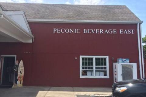 A notice to customers written on the Dos Equis beer man's sign reads, "I don't always drink beer, but when I do, I buy it from Peconic Beverage," while notifying them of the last day and to thank them for shopping.