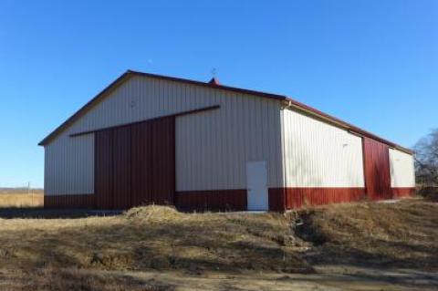 A steel barn on farmland in Amagansett built in 2016 sits vacant while several legal wrangles are worked out.