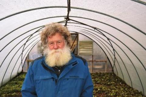 Scott Chaskey stood in an unheated greenhouse at Quail Hill, with rows of lettuce, baby spinach, and oriental greens for the winter share.