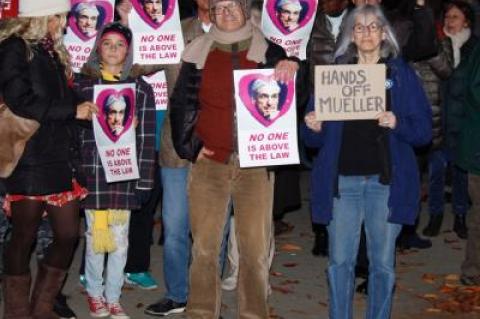 Protesters stood at the foot of Long Wharf in Sag Harbor Village Thursday night, one of 500 rallies nationwide promoted by the activist group MoveOn.