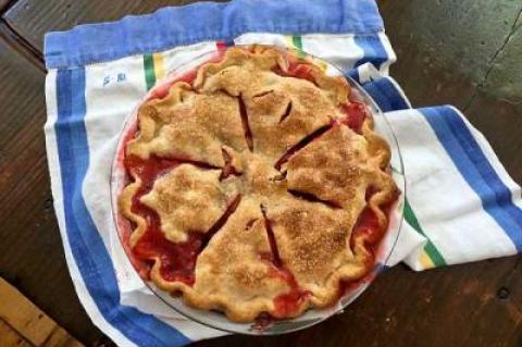 Use a glass pan for a strawberry rhubarb pie so you can check the bottom of the crust. It is also a good idea to watch it carefully and have something in the oven below the pan to catch the sticky overflow juices.