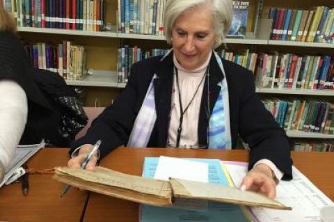 Eleanor Tritt, the Amagansett School superintendent, checked out a geography textbook from 1863 that once belonged to a student at the original Amagansett School, which was moved to the current school grounds recently.