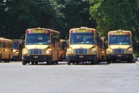 Buses lined up at the East Hampton School District's depot on Route 114, which the district leases.