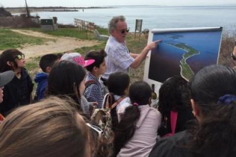 Tom Dwyer, a geologist who works for the Plum Island Animal Disease Center, showed aerial photos of the East End, including Plum Island, to children from John M. Marshall Elementary School during a 2015 field trip to the island.