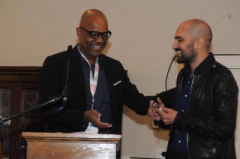 Shlomi Elkabetz, co-director and co-writer of "Gett: The Trial of Viviane Amsalem," accepts congratulations from juror Patrick Harrison for winning the Golden Starfish Narrative Feature Award.