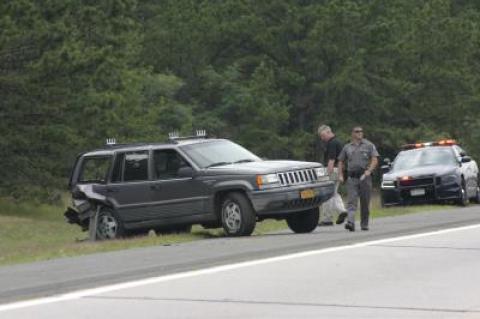 An East Hampton couple were hit by a car as they stood on the side of Sunrise Highway, observing a brush fire, on Saturday morning.