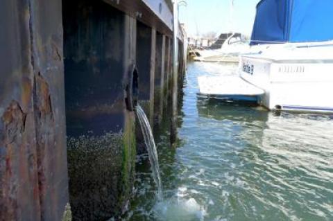 An East Hampton Town project would seek to block contaminants from reaching the surface of Three Mile Harbor.