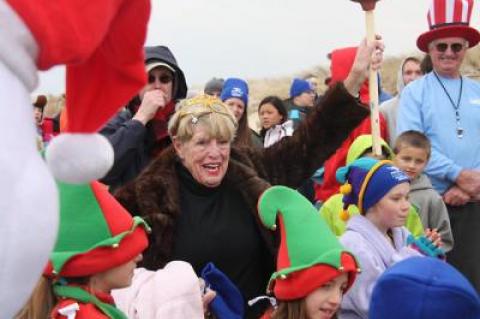 Joan Tulp wears a fur coat and a tiara to the East Hampton Main Beach Polar Bear Plunges.