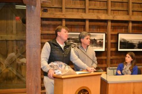 Richard A. Hammer, left, an attorney for the new owners of the East Deck motel property, held a bag of sand he said was similar to what will be used for a dune or berm on the ocean-facing side of the property. With him was Billy Mack of the First Coastal Corporation, which will be doing the work.