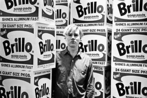 Fred W. McDarrah captured Andy Warhol at a Stable Gallery opening on April 21, 1964. Below: This 1965 image of Bob Dylan sitting on a bench outside The Village Voice’s offices was used on his “Complete Album Collection Vol. One” in 2013.