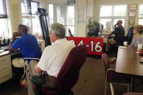 At East Hampton Airport on Monday morning, Town Supervisor Larry Cantwell, front, and Councilwoman Kathee Burke-Gonzalez, at right, joined Jemille Charlton, the airport manager, and Peter Boody, an airport staffer, to see how things stacked up as the first full weekend of an overnight curfew came to an end.