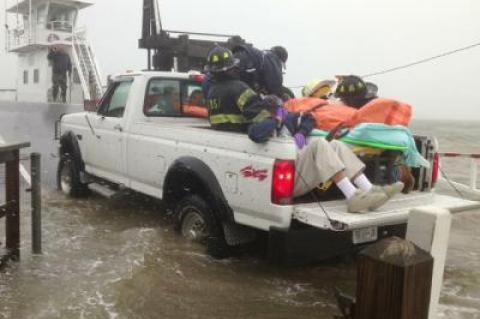 Emergency volunteers shielded a 92-year-old woman as she was taken onto a Shelter Island ferry Monday afternoon.