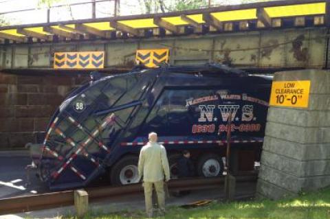 A National Waste Services garbage truck hit the North Main Street overpass on Tuesday morning.