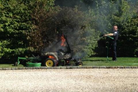 A Southampton Town police officer poured water from an outdoor hose onto the burning lawn mower.