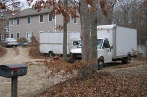 Pickup trucks with commercial or standard registration — and which do not have business signs or logos on them — would not be regulated, though panel trucks like these in East Hampton and others could be.