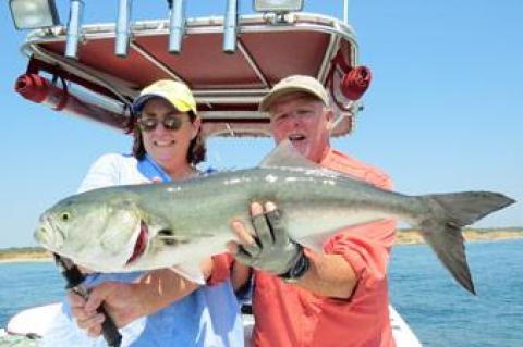 Capt. Ken Rafferty helped Patrice Neil of East Hampton hoist the 12-pound bluefish she caught off Montauk last week.