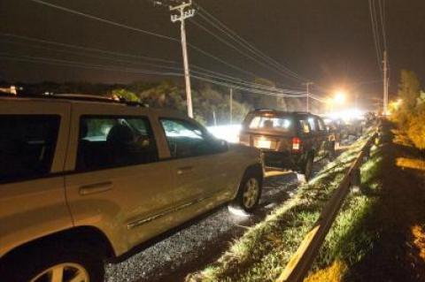 Cars parked on South Edgemere Road on a busy summer night outside The Surf Lodge in Montauk New York